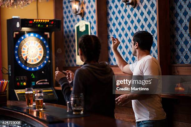 friends playing darts in a club - pub darts stock pictures, royalty-free photos & images