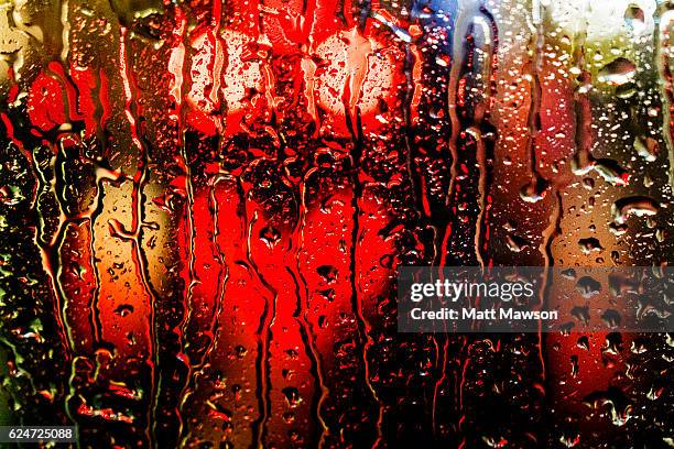 rain on a car windscreen and city lights reflecting on a wet street - car red light stock pictures, royalty-free photos & images