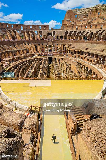 man walking by the colosseum, rome, italy - colosseum stock pictures, royalty-free photos & images