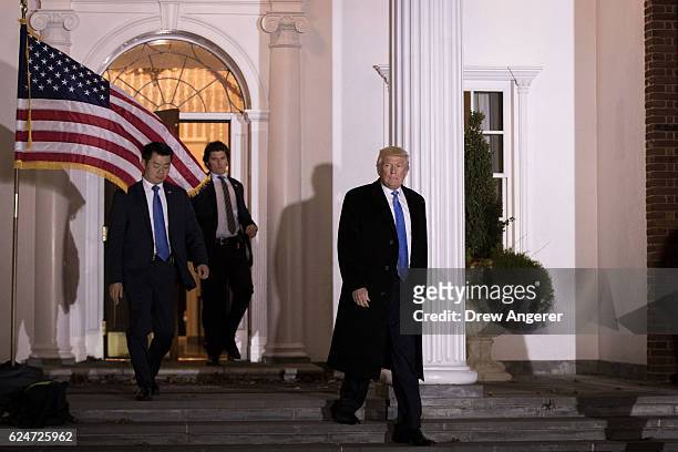 Trailed by U.S. Secret Service agents, President-elect Donald Trump leaves the clubhouse following a full day of meetings at Trump International Golf...