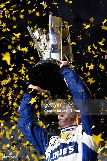 Jimmie Johnson, driver of the Lowe's Chevrolet, celebrates with the NASCAR Sprint Cup Series Championship trophy in Victory Lane after winning the...