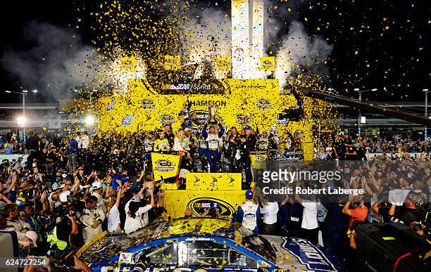 Jimmie Johnson, driver of the Lowe's Chevrolet, celebrates with the NASCAR Sprint Cup Series Championship trophy in Victory Lane after winning the...