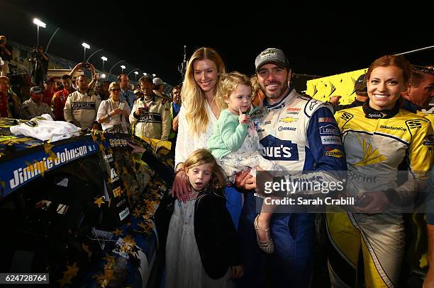 Jimmie Johnson, driver of the Lowe's Chevrolet, poses in Victory Lane with his wife Chandra and daughters Genevieve Marie and Lydia Norriss after...