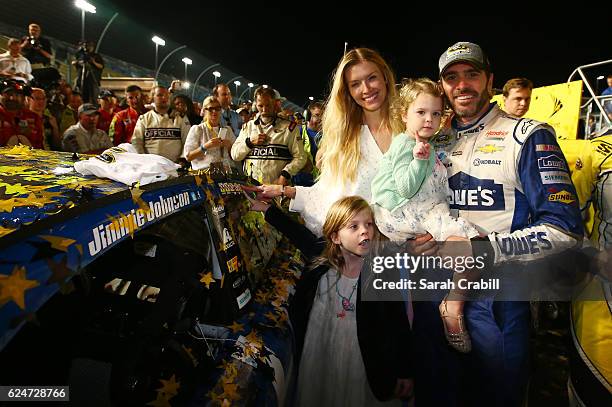 Jimmie Johnson, driver of the Lowe's Chevrolet, poses in Victory Lane with his wife Chandra and daughters Genevieve Marie and Lydia Norriss after...