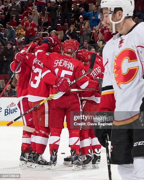 Tomas Tatar of the Detroit Red Wings celebrates his first period goal with teammates Riley Sheahan and Alexei Marchenko during an NHL game against...