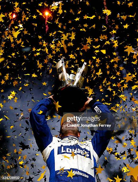 Jimmie Johnson, driver of the Lowe's Chevrolet, celebrates with the NASCAR Sprint Cup Series Championship trophy in Victory Lane after winning the...