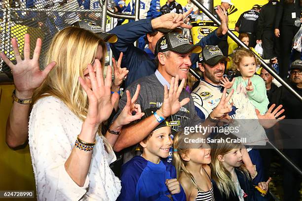 Jimmie Johnson, driver of the Lowe's Chevrolet, poses in Victory Lane with his wife Chandra, daughters Genevieve Marie and Lydia Norriss, and former...