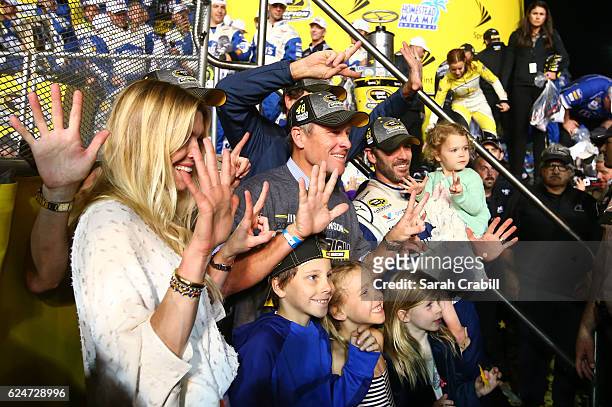 Jimmie Johnson, driver of the Lowe's Chevrolet, poses in Victory Lane with his wife Chandra, daughters Genevieve Marie and Lydia Norriss, and former...