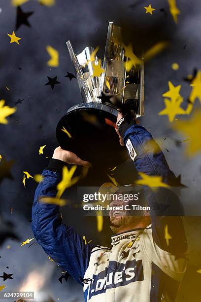 Jimmie Johnson, driver of the Lowe's Chevrolet, celebrates with the NASCAR Sprint Cup Series Championship trophy in Victory Lane after winning the...