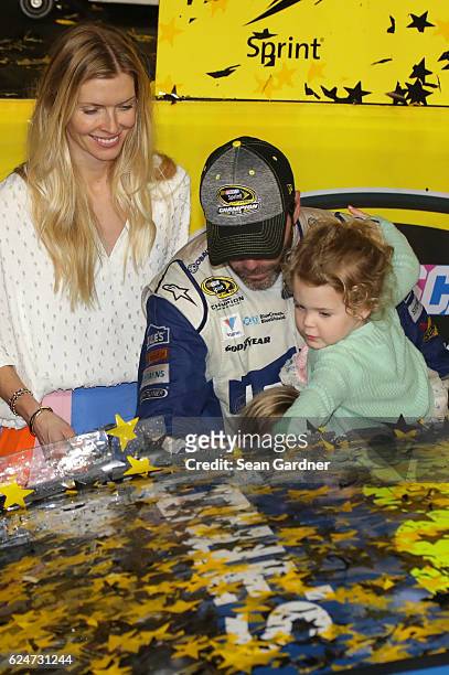 Jimmie Johnson, driver of the Lowe's Chevrolet, celebrates in Victory Lane with his wife Chandra and daughters Genevieve Marie and Lydia Norriss...