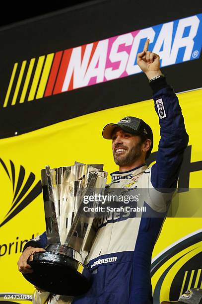 Jimmie Johnson, driver of the Lowe's Chevrolet, poses with the NASCAR Sprint Cup Series Championship trophy in Victory Lane after winning the NASCAR...