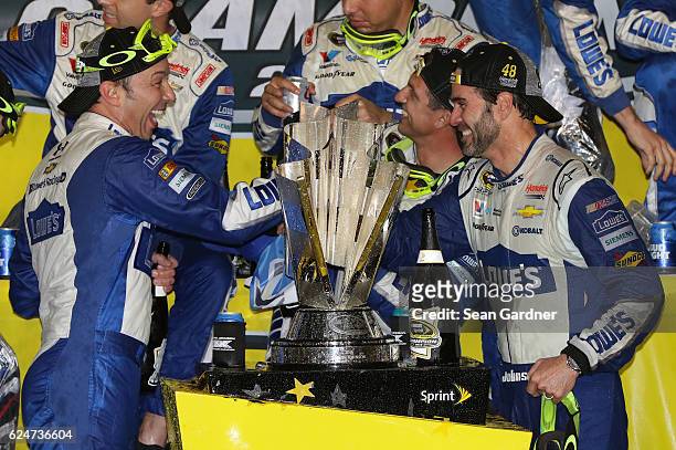 Jimmie Johnson , driver of the Lowe's Chevrolet, celebrates with crew chief Chad Knaus in Victory Lane after winning the NASCAR Sprint Cup Series...