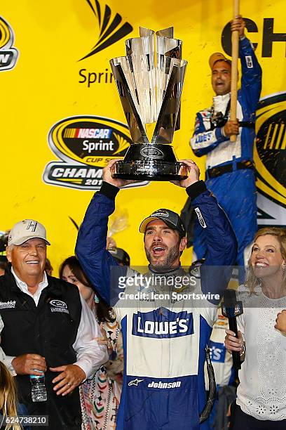 Jimmie Johnson celebrates in Victory Circle after winning the 18th annual Ford EcoBoost 400 NASCAR Sprint Cup Series race and the Series National...