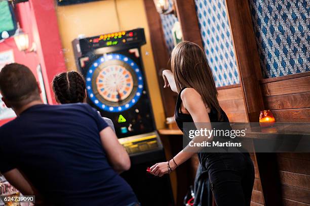 friends playing darts in a club - pub darts stock pictures, royalty-free photos & images