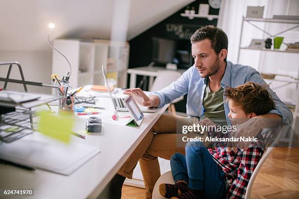 while dad is working... - fashionable dad stock pictures, royalty-free photos & images