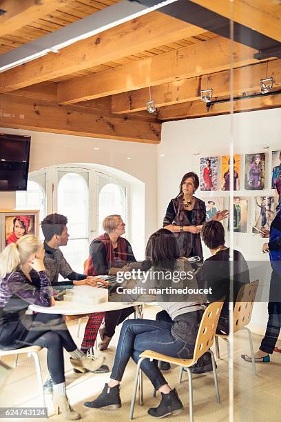 meeting in small creative start-up enterprise lead by woman. - small meeting stock pictures, royalty-free photos & images