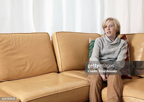 teenage boy by himself on couch. - tempe arizona stock pictures, royalty-free photos & images