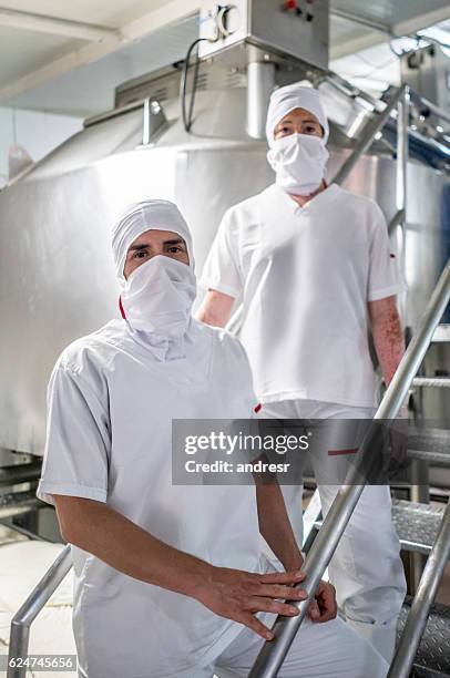 workers at a dairy factory - dairy factory stock pictures, royalty-free photos & images