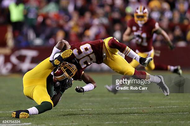 Running back James Starks of the Green Bay Packers is tackled by cornerback Bashaud Breeland of the Washington Redskins in the first quarter at...