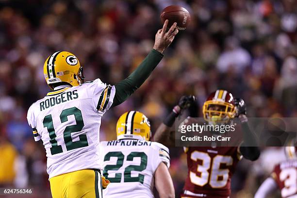 Quarterback Aaron Rodgers of the Green Bay Packers passes the ball against inside linebacker Su'a Cravens of the Washington Redskins in the first...