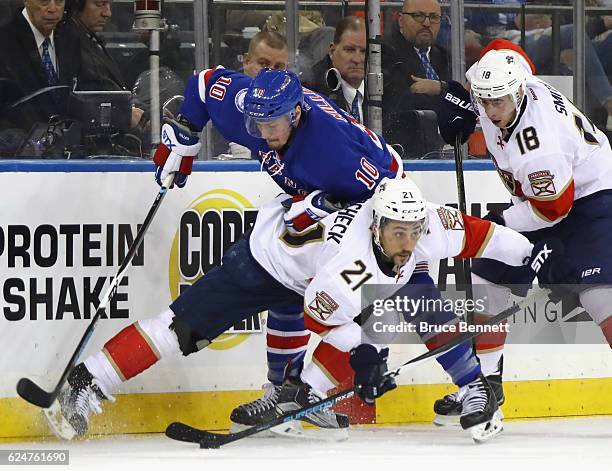 Vincent Trocheck of the Florida Panthers is tripped up by J.T. Miller of the New York Rangers during the third period at Madison Square Garden on...