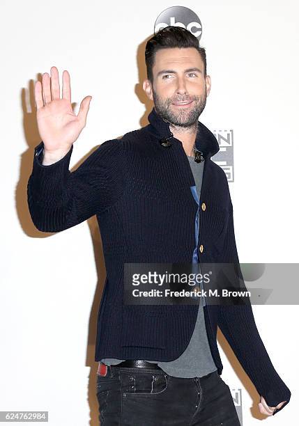 Singer-songwriter Adam Levine of musical group Maroon 5 poses in the press room during the 2016 American Music Awards at Microsoft Theater on...
