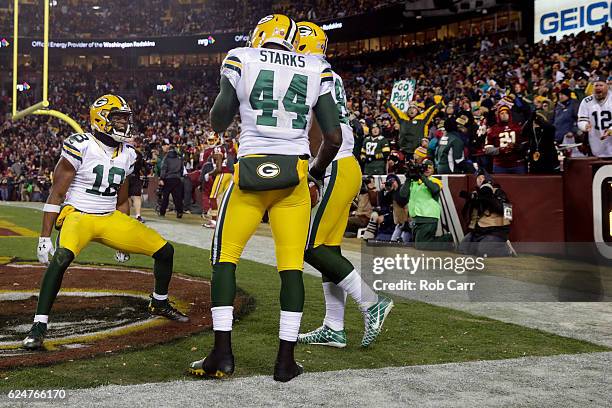 Running back James Starks of the Green Bay Packers celebrates with teammate wide receiver Randall Cobb after scoring a fourth quarter touchdown...