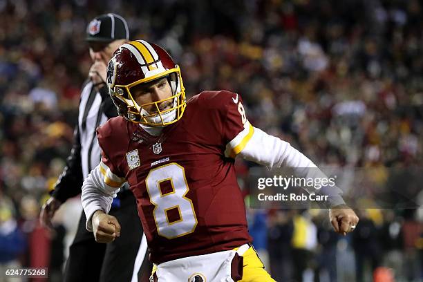 Quarterback Kirk Cousins of the Washington Redskins celebrates after teammate running back Rob Kelley , scores a fourth quarter touchdown against the...