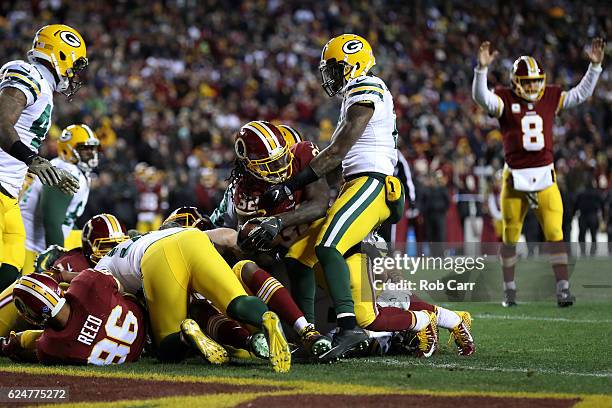 Running back Rob Kelley of the Washington Redskins scores a fourth quarter touchdown while teammate quarterback Kirk Cousins celebrates against the...