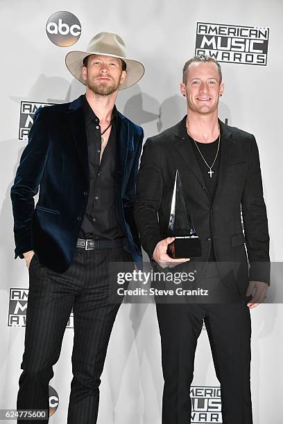 Musicians Brian Kelley and Tyler Hubbard of Florida Georgia Line, winners of the Favorite Country Duo or Group award pose in the press room during...
