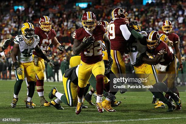 Running back Rob Kelley of the Washington Redskins scores a fourth quarter touchdown past defensive end Letroy Guion of the Green Bay Packers at...