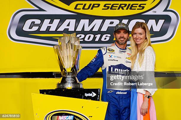 Jimmie Johnson, driver of the Lowe's Chevrolet, and his wife Chandra pose with the NASCAR Sprint Cup Series Championship trophy in Victory Lane after...