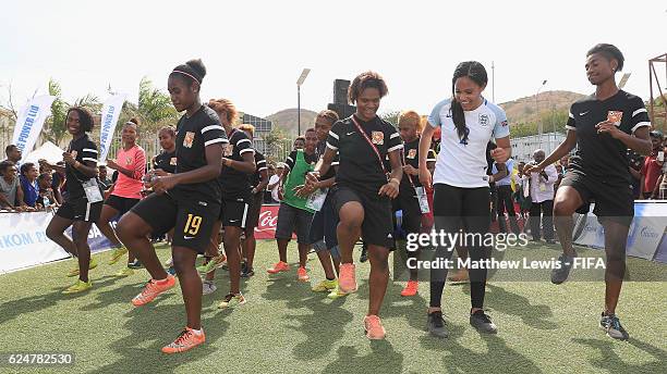 England and Arsenal footballer Alex Scott learns the 'Two step' dance with the Papua New Guinea team at the FanZone during the FIFA U-20 Women's...