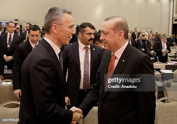 President of Turkey Recep Tayyip Erdogan shakes hands with NATO Secretary General Jens Stoltenberg during a plenary sitting held within the NATO...