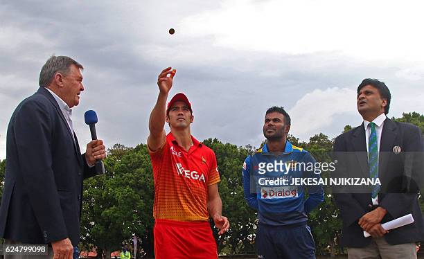 Zimbabwe's captain Graeme Cremer tosses a coin next to Sri Lanka's Upul Tharanga prior to the fourth One Day International cricket match in the...