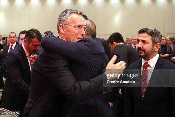 Secretary General Jens Stoltenberg and Turkish Foreign Minister Mevlut Cavusoglu greet each other during a plenary sitting held within the NATO...