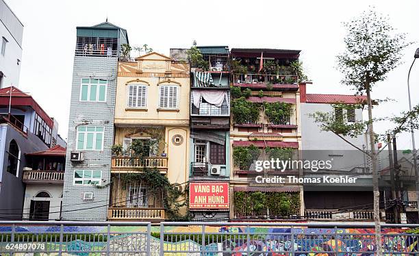 Hanoi, Vietnam Leafy multi-family houses on a street in Hanoi on October 30, 2016 in Hanoi, Vietnam.