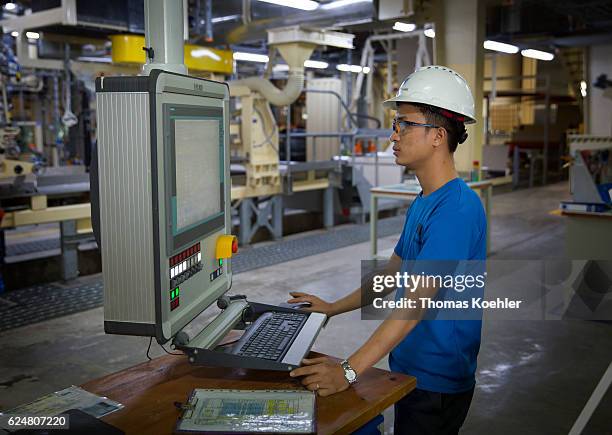 Hai Phong, Vietnam Production of gypsum boards at Knauf Vietnam Ltd. An employee controls a production line by computer on October 30, 2016 in Hai...