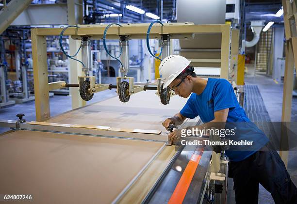 Hai Phong, Vietnam An employee is cutting gypsum boards at Knauf Vietnam Ltd. On October 30, 2016 in Hai Phong, Vietnam.