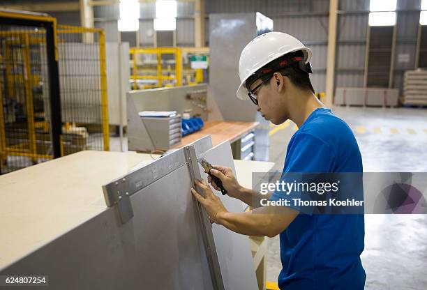 Hai Phong, Vietnam An employee is cutting gypsum boards at Knauf Vietnam Ltd. On October 30, 2016 in Hai Phong, Vietnam.