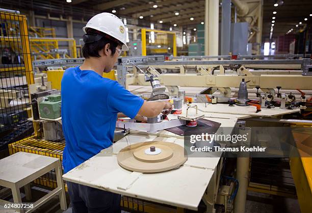 Hai Phong, Vietnam Production of gypsum boards at Knauf Vietnam Ltd. An employee sets up a labeling machine on October 30, 2016 in Hai Phong, Vietnam.