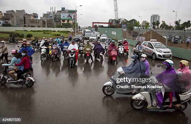 Hanoi, Vietnam Moped driver with respiratory masks in city traffic in Hanoi on October 30, 2016 in Hanoi, Vietnam.