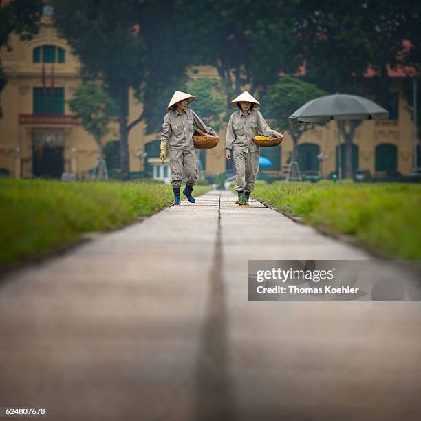 Hanoi, Vietnam Two gardeners walk through the park in front of the Ho Chi Minh Mausoleum in Hanoi on October 31, 2016 in Hanoi, Vietnam.