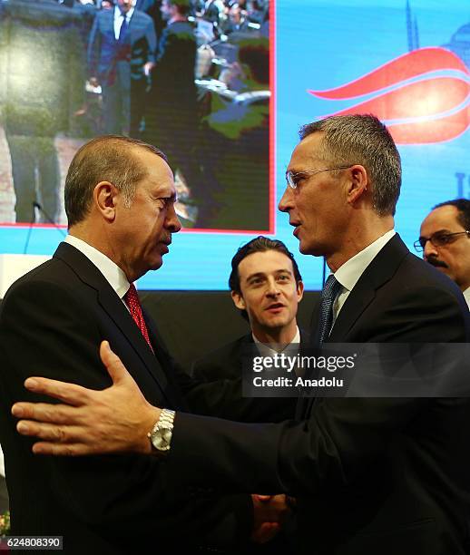 President of Turkey Recep Tayyip Erdogan shakes hands with NATO Secretary General Jens Stoltenberg during a plenary sitting held within the NATO...