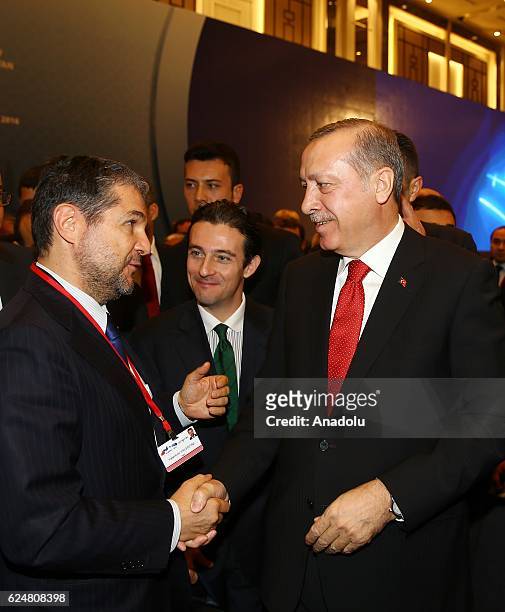 President of Turkey Recep Tayyip Erdogan shakes hands with member of Italian parliament Valentino Valentini during a plenary sitting held within the...