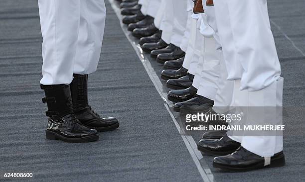An Indian Navy officer inspects the uniforms of an honour guard alongside the INS Chennai destroyer before it is commissioned into the Indian Navy in...