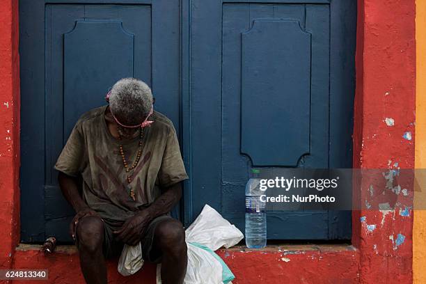 Beggar is seen with a crucifix during the festivities. Afro-descendent musical groups make a presentation in honor of the National Day of Black...