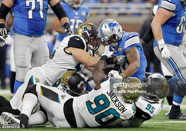 Detroit Lions running back Dwayne Washington is tackled by Jacksonville Jaguars defensive tackle Abry Jones as middle linebacker Paul Posluszny...