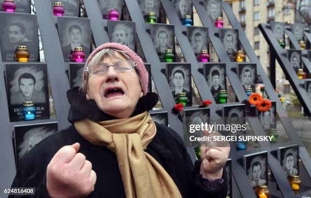 An elderly woman cries at the memorial for the killed Maidan activists during a ceremony marking the third anniversary of the Euromaidan beginning in...