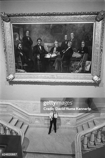 Capitol police officer stands beneath Francis Bicknell Carpenter's 1864 painting 'First Reading of the Emancipation Proclamation by President...